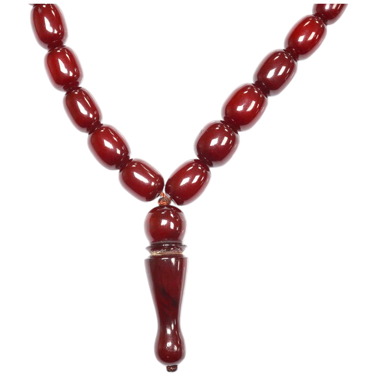 A Persian single strand simulated cherry amber drop bead necklace, 64cm, gross weight 54 grams. Condition - fair to good